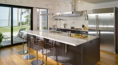 View of contemporary kitchen which features island, stainless countertop, interior design, kitchen, real estate, gray, brown