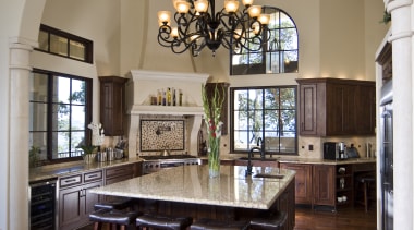 View of a Tuscan-styled kitchen which features dark-stained ceiling, dining room, estate, floor, flooring, furniture, hardwood, home, interior design, living room, real estate, room, table, window, wood flooring, gray, brown