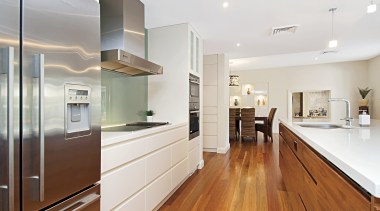 View of this contemporary home by Balmoral Homes cabinetry, countertop, floor, flooring, hardwood, interior design, kitchen, laminate flooring, real estate, room, wood, wood flooring, white