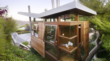 Exterior view of a contemporary tree house with home, house, outdoor structure, roof, shed, brown, teal