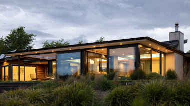 The renovated and extended home at dusk. - 