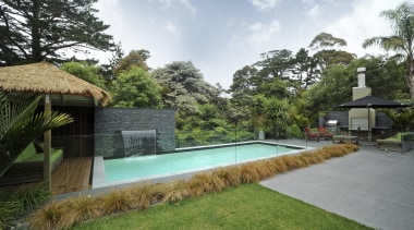 Exterior view of an outdoor area which features area, arecales, backyard, cottage, estate, hacienda, home, house, landscape, leisure, palm tree, property, real estate, residential area, resort, swimming pool, villa, yard