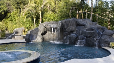 Exterior view of the Tran Residence which features backyard, body of water, landscape, leisure, pond, swimming pool, water, water feature, water resources, watercourse, waterfall, gray