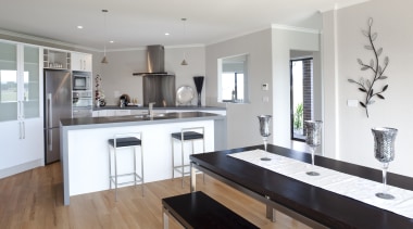 View of Platinum Homes show home with solid cabinetry, countertop, cuisine classique, floor, flooring, interior design, kitchen, property, real estate, room, gray