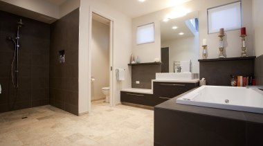 View of contemporary home with dark cabinetry, wooden bathroom, estate, floor, flooring, home, interior design, property, real estate, room, tile, gray, black