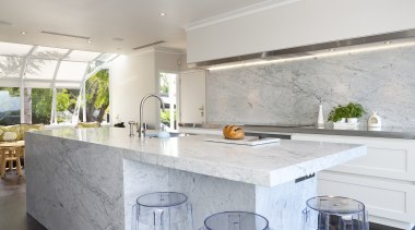 Carrara marble is used to create a centerpiece architecture, ceiling, countertop, floor, home, house, interior design, kitchen, real estate, room, table, gray, white