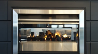 View of dark-toned indoor fireplace. - View of black
