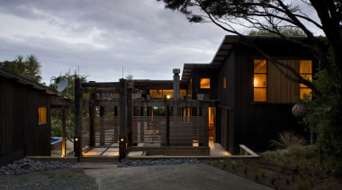 The timber for this house is treated with architecture, building, cottage, evening, facade, home, house, lighting, real estate, residential area, black, gray