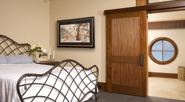 This is the master suite of the house bed frame, bedroom, door, estate, floor, furniture, home, interior design, property, real estate, room, window, wood, orange, brown