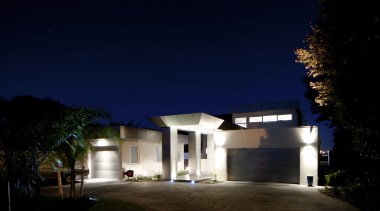 This house was designed and built by Signature architecture, building, darkness, estate, facade, home, house, landscape lighting, light, lighting, night, property, real estate, residential area, sky, blue, black