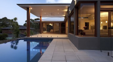 Exterior view of east facing house and pool. architecture, estate, home, house, lighting, property, real estate, reflection, swimming pool, villa, window