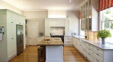 View of contemporary kitchen with wooden flooring and cabinetry, countertop, cuisine classique, floor, hardwood, interior design, kitchen, real estate, room, white