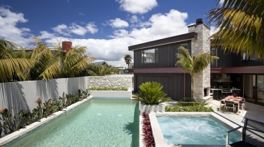 View of pool area of contemporary home. - arecales, backyard, estate, home, house, leisure, palm tree, property, real estate, residential area, resort, swimming pool, villa