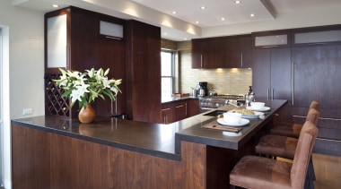 Dark wooden cabinetry, dark coloured benchtop, white walls cabinetry, countertop, interior design, kitchen, real estate, room, red, gray