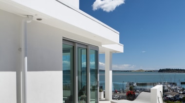 Situated to one side of this house, yet apartment, architecture, condominium, daylighting, home, house, interior design, outdoor furniture, property, real estate, sky, sunlounger, table, white