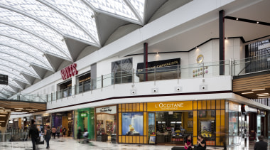View of interior of mall. - View of building, mixed use, outlet store, retail, shopping mall, white