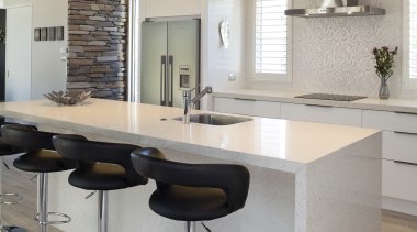 Kitchen with white island, white cabinetry, stainless hood countertop, floor, flooring, furniture, interior design, kitchen, product design, table, gray