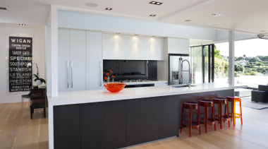 View of contemporary kitchen with wooden flooring, white countertop, house, interior design, kitchen, real estate, gray, white