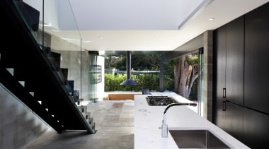 Kitchen near stairs. White countertop, black cabinetry. See architecture, house, interior design, white, black