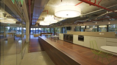 Interior with long wooden divider and exposed red interior design, leisure centre, brown