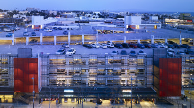 View of parking building at dusk. - View architecture, building, city, cityscape, condominium, daytime, evening, metropolis, metropolitan area, mixed use, port, real estate, reflection, residential area, sky, structure, suburb, urban area, water, teal, blue