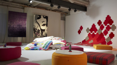 Colourful red design on wall, round orange seat bed, ceiling, furniture, interior design, room, wall, gray