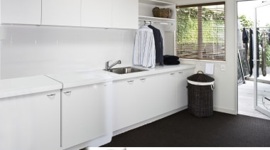 Laundry with white appliances and white cupboards. countertop, floor, interior design, kitchen, product design, room, white