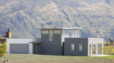 David Reid Homes. Exterior of house in Otago architecture, cottage, elevation, facade, farmhouse, home, house, hut, mountain, property, real estate, roof, sky, gray