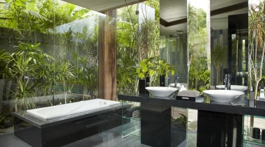 Floor-to-ceiling glass opens up this bathroom to the interior design, brown