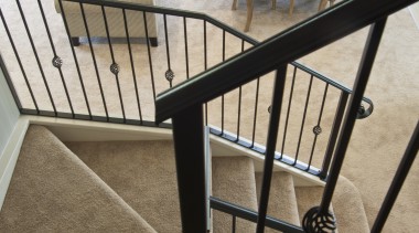 wrought iron banister carpeted stairs leading to lounge baluster, chair, floor, flooring, furniture, handrail, iron, product, stairs, table, brown, white