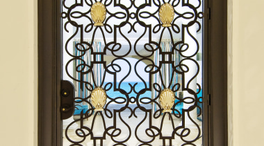 This home was designed by Geoffrey Bradfield. Here glass, iron, stained glass, window, yellow, brown