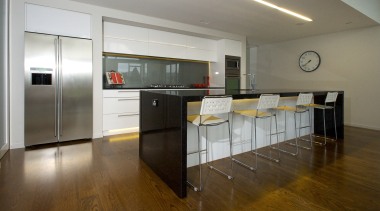 This modern kitchen is by Kitchen Focus. The countertop, floor, flooring, hardwood, interior design, kitchen, laminate flooring, real estate, room, wood flooring, brown, gray