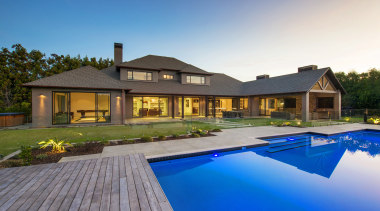 This contemporary, well-balanced masonry home was designed and backyard, cottage, estate, facade, home, house, leisure, mansion, property, real estate, residential area, resort, roof, swimming pool, villa, teal