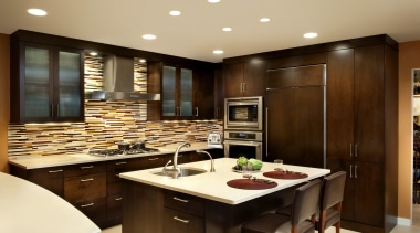 Understated dark wood cabinetry and cream countertops are cabinetry, countertop, cuisine classique, interior design, kitchen, orange, red