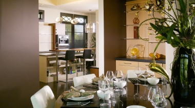 This formal dining area is positioned beside a dining room, furniture, home, interior design, living room, restaurant, room, table, brown