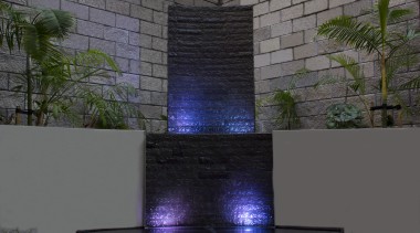 This water feature at night turns a bland, light, reflection, wall, gray, black