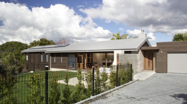 Expansive north-facing glazing and solar panels on the cottage, elevation, estate, facade, home, house, property, real estate, residential area, roof, suburb, gray