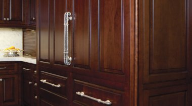 In this kitchen remodel, low-set drawers contain pots cabinetry, chest of drawers, closet, countertop, cupboard, drawer, furniture, hardwood, kitchen, room, wardrobe, wood, wood stain, red