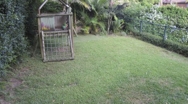 A minimal material palette of travertine pavers, blue area, backyard, fence, garden, grass, grass family, hedge, house, land lot, lawn, nature reserve, outdoor structure, plant, property, real estate, shrub, tree, yard, green