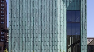 A recessed window on the front of the architecture, building, city, commercial building, condominium, corporate headquarters, daytime, downtown, facade, headquarters, landmark, metropolis, metropolitan area, mixed use, real estate, residential area, sky, skyscraper, tower block, urban area, teal