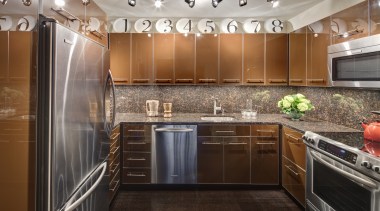 A row of decorative plates enliven the top cabinetry, ceiling, countertop, cuisine classique, interior design, kitchen, real estate, room, under cabinet lighting, brown, gray, black