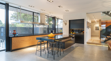 Rich orange wood veneer balances jet black engineered architecture, house, interior design, living room, real estate, gray