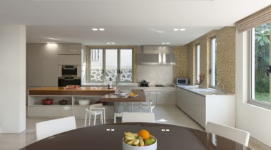 A large L-shaped island is the centrepiece of ceiling, countertop, interior design, kitchen, living room, real estate, gray