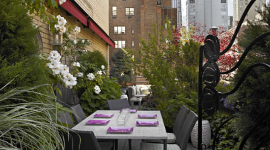 Antique steel gates acquired by the owners frame backyard, courtyard, flower, garden, home, neighbourhood, outdoor structure, patio, plant, tree, brown, black