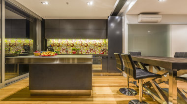 Mal Corboy kitchen with Smeg appliances.  Black countertop, flooring, interior design, kitchen, real estate, room, brown, orange