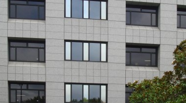 Durable, good-looking carpet tiles for commercial use apartment, architecture, building, commercial building, condominium, corporate headquarters, facade, headquarters, metropolitan area, mixed use, residential area, window, gray