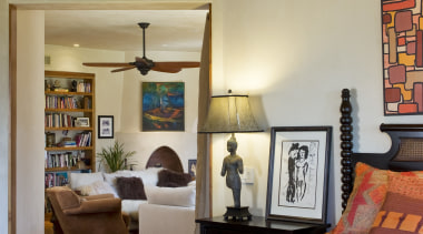 Colorful fabrics and indigenous treasures collected by the ceiling, estate, furniture, home, interior design, living room, real estate, room, wall, orange, brown