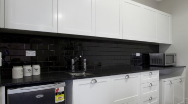 White limante kitchen with stainless steel appliances cabinetry, countertop, cuisine classique, interior design, kitchen, kitchen stove, room, gray, black