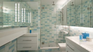 A line of mirrors bounces light around this bathroom, floor, glass, home, interior design, room, tile, gray, green