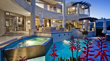 Water cascades down from an infinity edge pool, estate, home, hotel, leisure, leisure centre, property, real estate, resort, resort town, swimming pool, water